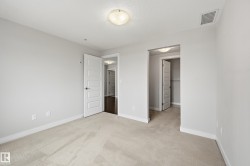 Neutral-toned carpeting and light gray walls create a versatile interior - 
