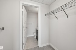 Walk-in closet featuring wire shelving and light gray carpeting - 