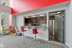 Open-concept common area featuring a kitchen pass-through with counter seating - 