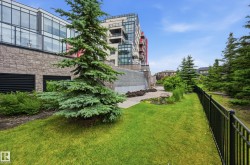 Manicured lawn area featuring a black metal fence - 