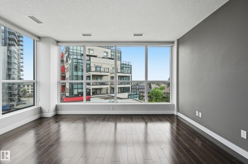 Expansive window wall with multiple panes offering city views - 528 5151 Windermere Boulevard, Edmonton, AB 
