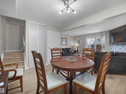 Open-concept living space with wood-finish flooring - 