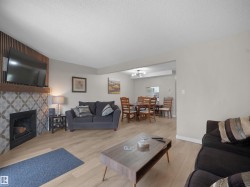 Living area with light-toned wood-finish flooring - 