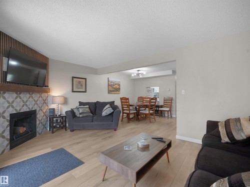 Living area with light-toned wood-finish flooring - 575 Dunluce Road, Edmonton, AB 