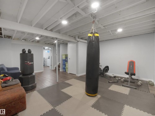 Lower level featuring a painted open ceiling with recessed lighting, wood-finish flooring, and light gray walls - 575 Dunluce Road, Edmonton, AB 