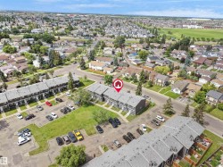 Aerial perspective highlighting two-story townhomes with gray exteriors and shingled roofs - 