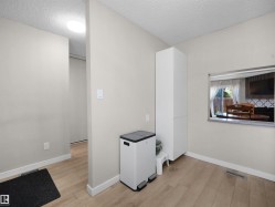 Light wood-finish flooring extending into the hallway - 