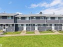 Row of townhomes featuring charcoal grey siding and white trim - 575 Dunluce Road, Edmonton, AB 