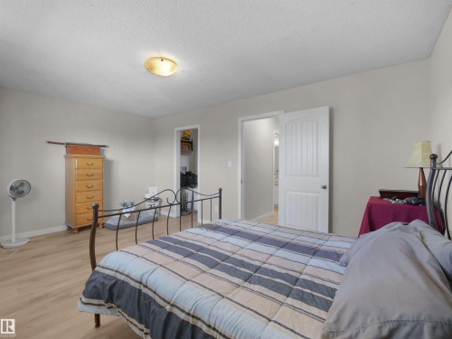 Light-colored walls complement the wood-finish flooring in this room - 575 Dunluce Road, Edmonton, AB 
