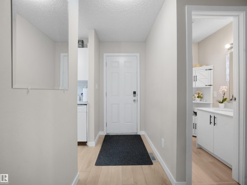 Entryway with wood-finish flooring and a paneled door - 575 Dunluce Road, Edmonton, AB 