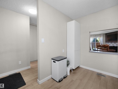 Light wood-finish flooring extending into the hallway - 575 Dunluce Road, Edmonton, AB 