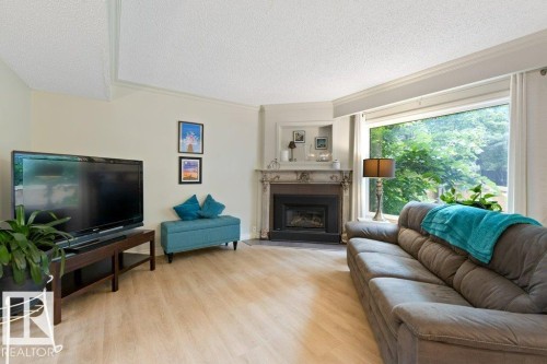 119 Grandin Woods Estates, St. Albert, AB - Indoor Photo Showing Living Room With Fireplace