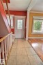 Entryway featuring light-toned tile flooring and a decorative glass-paneled door - 11312 127 Street, Edmonton, AB 