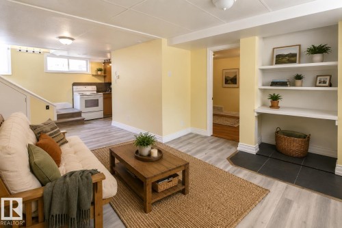 Finished living space with recessed lighting, light wood-finish flooring, built-in shelving, and a white oven/range - 11312 127 Street, Edmonton, AB 