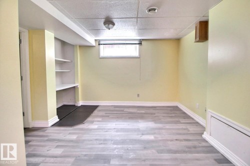 Finished room featuring wood-finish flooring and built-in shelving - 11312 127 Street, Edmonton, AB 