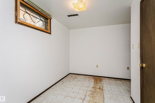 Room featuring white painted walls and patterned floor tiling - 11440 44A Avenue, Edmonton, AB 