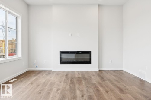 2482 Egret Loop Nw, Edmonton, AB - Indoor Photo Showing Living Room With Fireplace