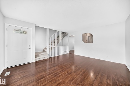 Spacious living area featuring rich wood-finish flooring - 11447 22 Avenue Nw, Edmonton, AB 