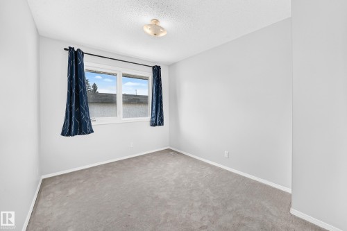 Bright room with a large window and light gray carpet - 11447 22 Avenue Nw, Edmonton, AB 
