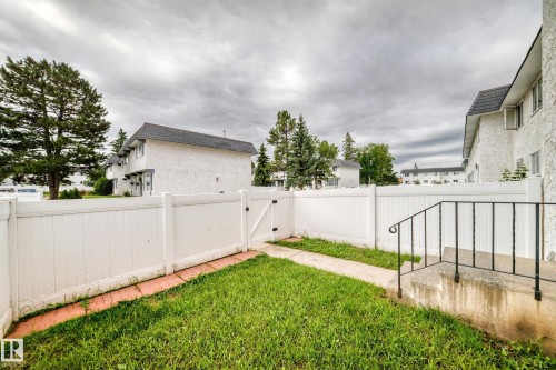Private outdoor space featuring a white privacy fence and a small lawn area - 11447 22 Avenue Nw, Edmonton, AB 