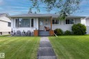 Single-story residence featuring a light-colored stucco exterior with white trim windows - 10623 75 Street Nw, Edmonton, AB 