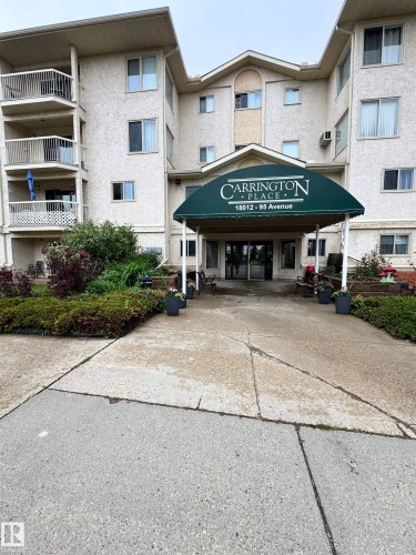 Multi-story residential building featuring a stucco facade and multiple private balconies - 207 18012 95 Avenue, Edmonton, AB 
