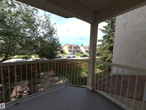 Private balcony featuring a textured concrete floor and metal railings - 207 18012 95 Avenue, Edmonton, AB 