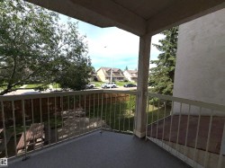 Private balcony featuring a textured concrete floor and metal railings - 