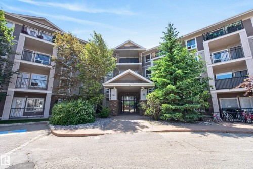 Multi-story building exterior featuring a neutral color palette with dark accents - #6223 7331 South Terwillegar Dr Nw, Edmonton, AB - Outdoor With Balcony With Facade
