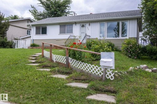 Single-story residence featuring white siding and a contrasting tan lower exterior - 5608 122 Avenue, Edmonton, AB 