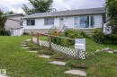 Single-story residence featuring white siding and a contrasting tan lower exterior - 5608 122 Avenue, Edmonton, AB 