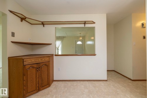 Corner built-in cabinetry with wood-finish doors and a countertop - 5608 122 Avenue, Edmonton, AB 
