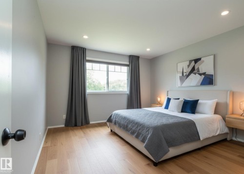 Bedroom featuring wood-finish flooring, recessed lighting, and a multi-pane window - 5608 122 Avenue, Edmonton, AB 