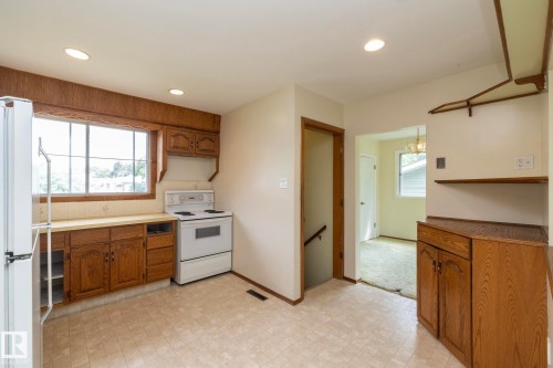 Kitchen featuring wood-finish cabinetry, a window over the sink, and recessed lighting - 5608 122 Avenue, Edmonton, AB 
