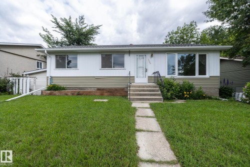Single-story residence featuring white siding with a contrasting horizontal panel accent - 5608 122 Avenue, Edmonton, AB 