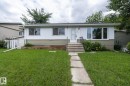 Single-story residence featuring white siding with a contrasting horizontal panel accent - 5608 122 Avenue, Edmonton, AB 