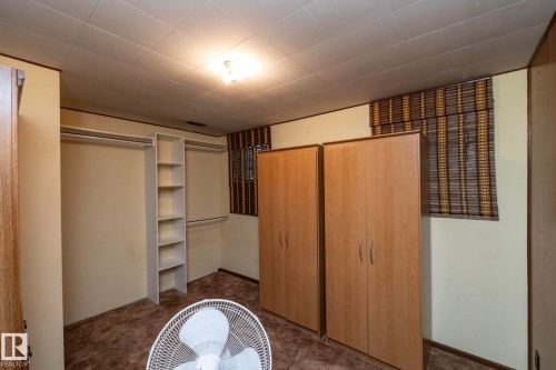 Room with neutral-toned walls, textured ceiling, and a central light fixture - 5608 122 Avenue, Edmonton, AB 