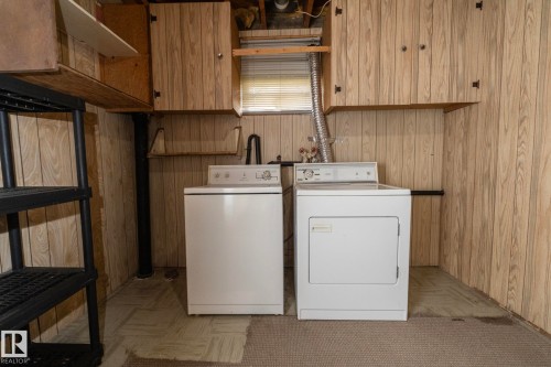 Dedicated laundry area featuring a white washer and dryer pair - 5608 122 Avenue, Edmonton, AB 