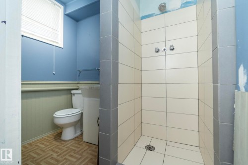 Tiled shower with chrome fixtures and light-toned horizontal tile work - 5608 122 Avenue, Edmonton, AB 