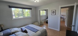 Bedroom featuring wood-finish flooring and a window with exterior views - 