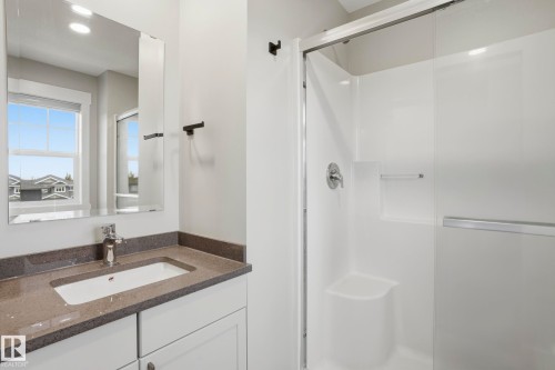 Bathroom featuring a white vanity with a rectangular undermount sink, a gray speckled countertop, and a chrome faucet - 36 150 Everitt Dr, St. Albert, AB - Indoor Photo Showing Bathroom