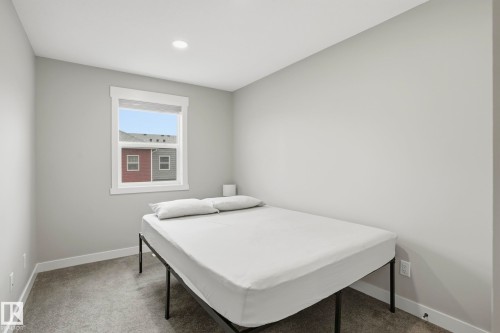Room featuring neutral gray walls, gray carpet, a single window with white trim, and a recessed ceiling light - 36 150 Everitt Dr, St. Albert, AB - Indoor Photo Showing Bedroom