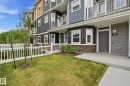 Townhome exterior featuring multi-toned siding, white trim windows, and private balconies with white railings - 36 150 Everitt Dr, St. Albert, AB  - Outdoor With Balcony 
