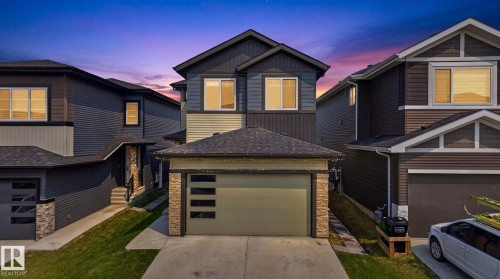Contemporary two-story residence featuring a two-tone exterior with dark siding and light accents - 423 42 Street, Edmonton, AB 