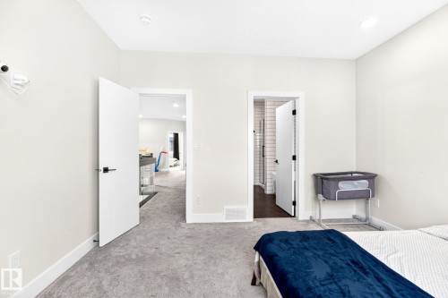 Light-toned carpeting in a neutral room with two doorways - 423 42 Street, Edmonton, AB 