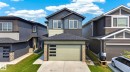 Modern two-story residence featuring multi-toned siding, stone accents, and a two-car garage with horizontal panel details - 423 42 Street, Edmonton, AB 