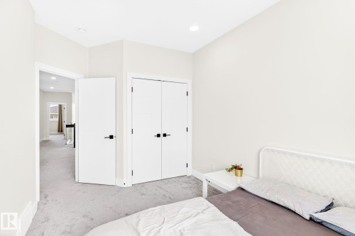 Interior room featuring light gray carpet, recessed lighting, and a neutral wall color - 423 42 Street, Edmonton, AB 