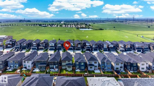 Aerial perspective showcasing a residential development with varied exterior finishes and private rear yards - 423 42 Street, Edmonton, AB 