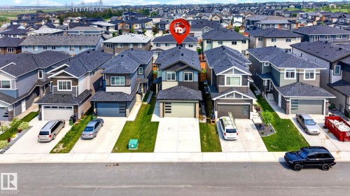 Contemporary two-story residence with a dark grey exterior, white trim accents, and a dark shingle roof - 423 42 Street, Edmonton, AB 