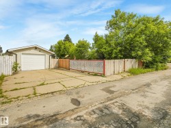 Detached garage featuring an overhead door and a stucco exterior finish - 